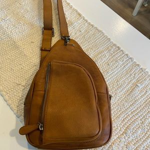 Brown leather sling backpack style purse
